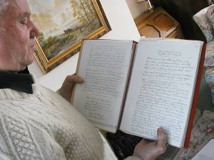 Bob with a book of photocopies of song words in Henry Burstow's hand. They came to Bob from Gordon Hall, but Bob does not know where the originals reside.